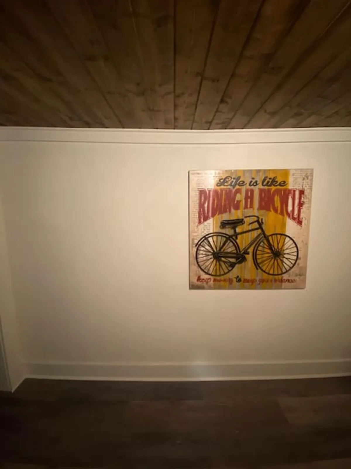 A piece of vintage bicycle artwork serves as the focal point in this cozy setting, suggesting the joy and nostalgia of outdoor adventures. The surrounding space invites quiet contemplation or conversation inspired by travel and exploration.